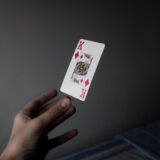 person holding king of diamonds playing card